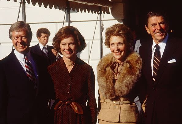 Outgoing US President Jimmy Carter (left) and First Lady Rosalynn Carter (second left) receive President-Elect Ronald Reagan and (future First Lady) Nancy Reagan at the White House, Washington DC, November 20, 1980. Reagan had just defeated Carted in the 1980 Presidential Election. (Photo by Diana Walker/Getty Images)