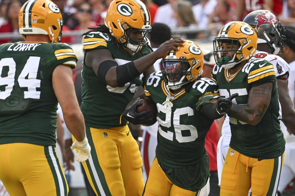 Green Bay Packers' Darnell Savage is congratulated after recovering a fumble during the first half of an NFL football game against the Tampa Bay Buccaneers Sunday, Sept. 25, 2022, in Tampa, Fla. (AP Photo/Jason Behnken)