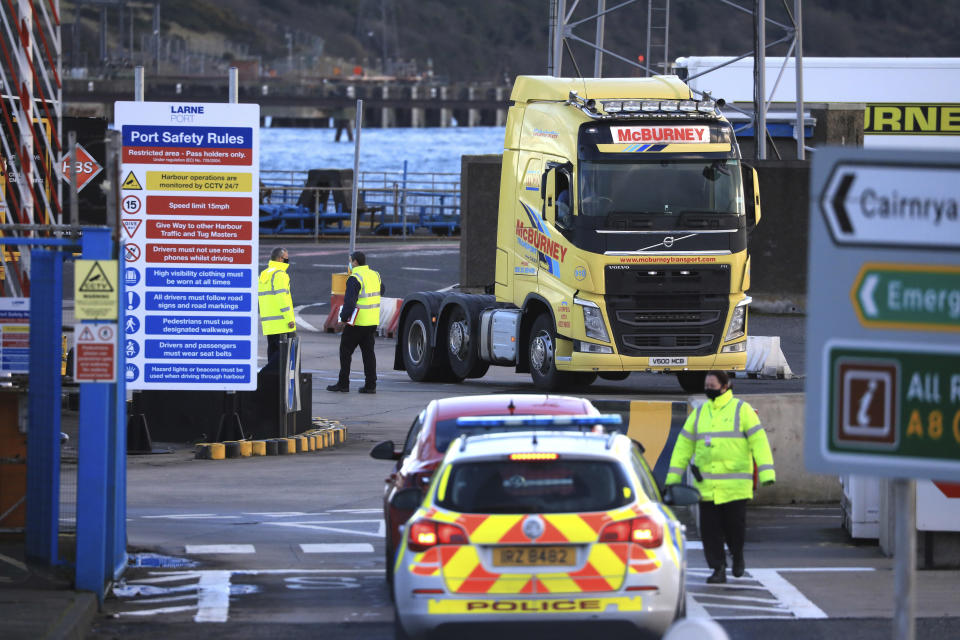 Customs officials check vehicles at the P&O ferry terminal in the port at Larne on the north coast of Northern Ireland, Friday, Jan. 1, 2021. This New Year's Day is the first day after Britain's Brexit split with the European bloc's vast single market for people, goods and services, and the split is predicted to impact the Northern Ireland border. (AP Photo/Peter Morrison)