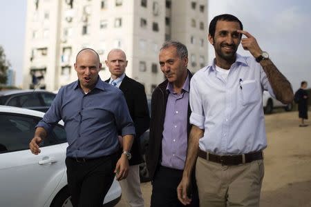 Israel's Economy Minister Naftali Bennett (L), head of far-right Jewish Home party, arrives at a shopping mall to campaign in the southern city of Ashkelon February 3, 2015. REUTERS/Amir Cohen