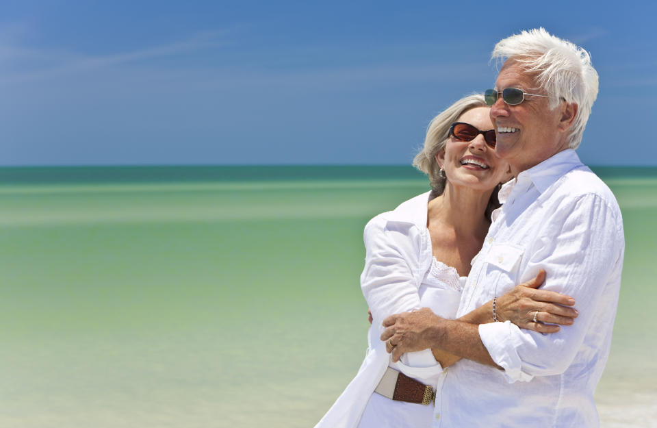 Older couple embracing at the beach