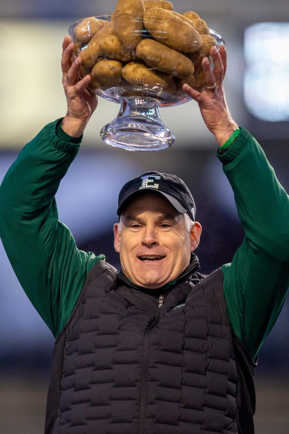 Eastern Michigan coach Chris Creighton lifts the trophy after of the 41-27 win over San Jose State in the Famous Idaho Potato Bowl on Tuesday, Dec. 20, 2022, in Boise, Idaho.