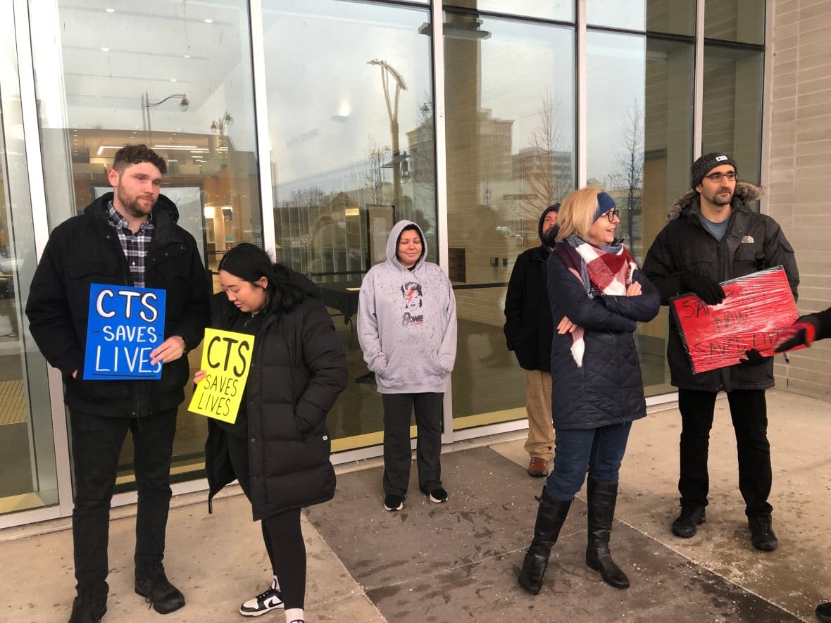 People rally outside of city council in support of the consumption treatment and services site on Wyandotte Street East.  (Dale Molnar/CBC - image credit)