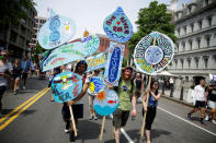 Protesters carry signs during the Peoples Climate March near the White House in Washington, U.S., April 29, 2017. REUTERS/Joshua Roberts