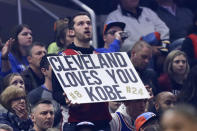 A fan holds up a sign about Kobe Bryant during the first half of an NBA basketball game between the Cleveland Cavaliers and the New Orleans Pelicans, Tuesday, Jan. 28, 2020, in Cleveland. Bryant, his 13-year-old daughter Gianna and six other passengers were killed along with the pilot Sunday. (AP Photo/Tony Dejak)