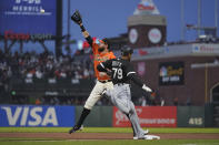 San Francisco Giants first baseman Brandon Belt reaches for the throw as Chicago White Sox's Jose Abreu (79) runs to first base for an infield single during the fourth inning of a baseball game in San Francisco, Friday, July 1, 2022. (AP Photo/Eric Risberg)