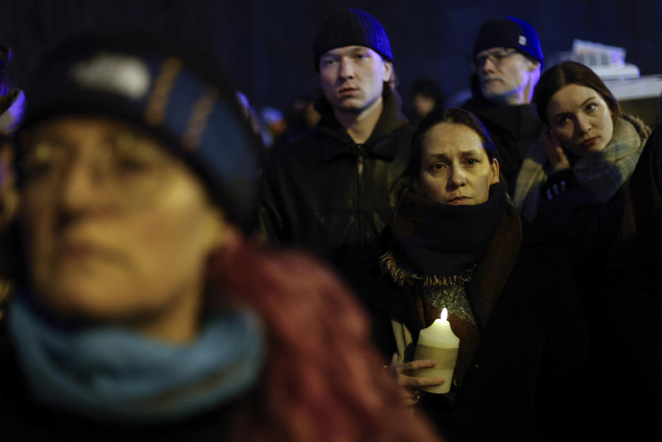 People march in silence to commemorate Lizaveta, a 25-year-old Belarusian woman who died after a being brutally attacked and raped on the streets of Warsaw last month, in Warsaw Poland, Wednesday, March 6, 2024. The crime has shocked people across Poland. Poles, Belarusians and Ukrainians gathered at the site of the crime in downtown Warsaw, placing flowers and lighting candles in honor of the woman known only as Lizaveta, or Liza. (AP Photo/Michal Dyjuk)