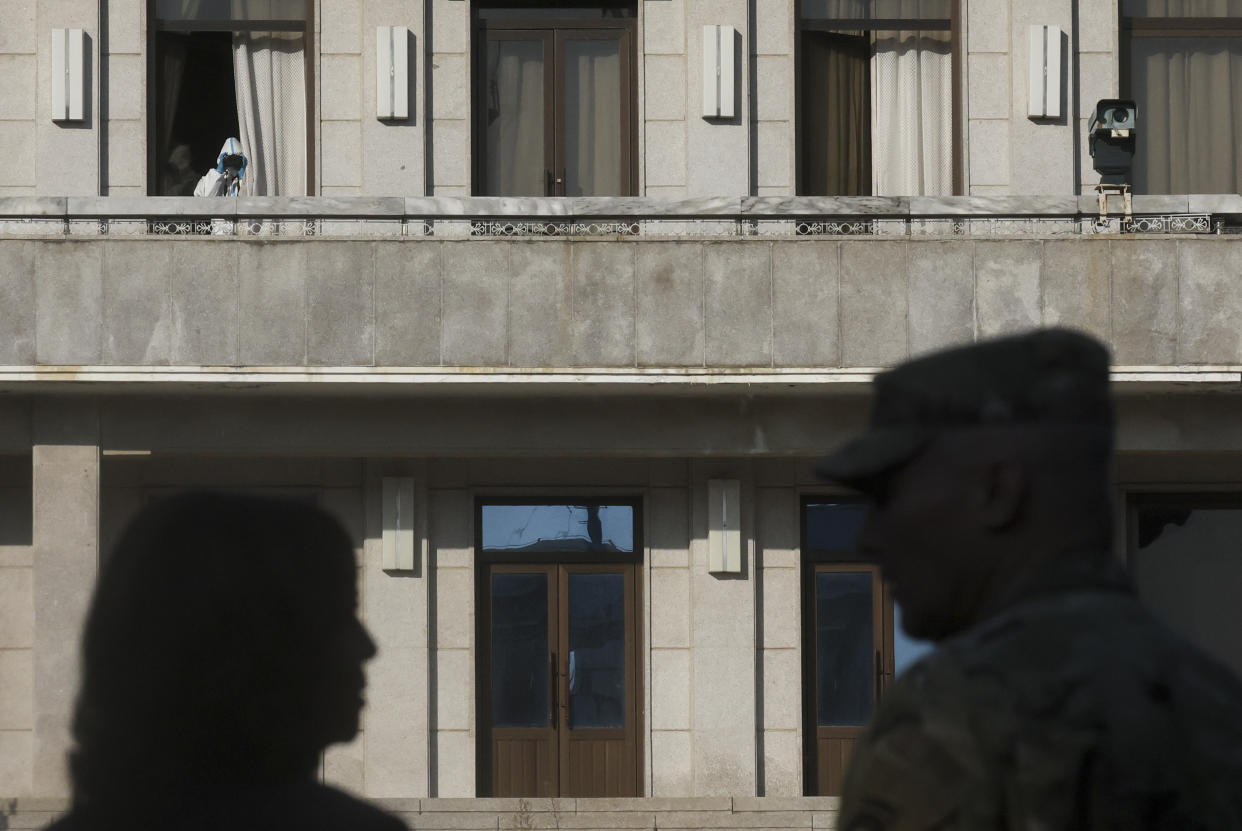 A soldiers on the North Korean side looks through binoculars as U.S. Vice President Kamala Harris visits the demilitarized zone (DMZ) separating the two Koreas, in Panmunjom, South Korea, Thursday, Sept. 29, 2022. (Leah Millis/Pool Photo via AP)
