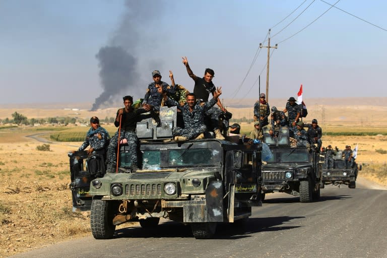 Iraqi government forces celebrate as they take the Havana oil field in the disputed northern province of Kirkuk from the Kurds on October 17, 2017