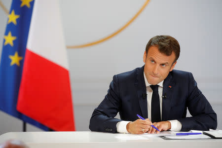 French President Emmanuel Macron takes notes as he listens to a question during a news conference to unveil his policy response to the yellow vests protest, at the Elysee Palace in Paris, France, April 25, 2019. REUTERS/Philippe Wojazer