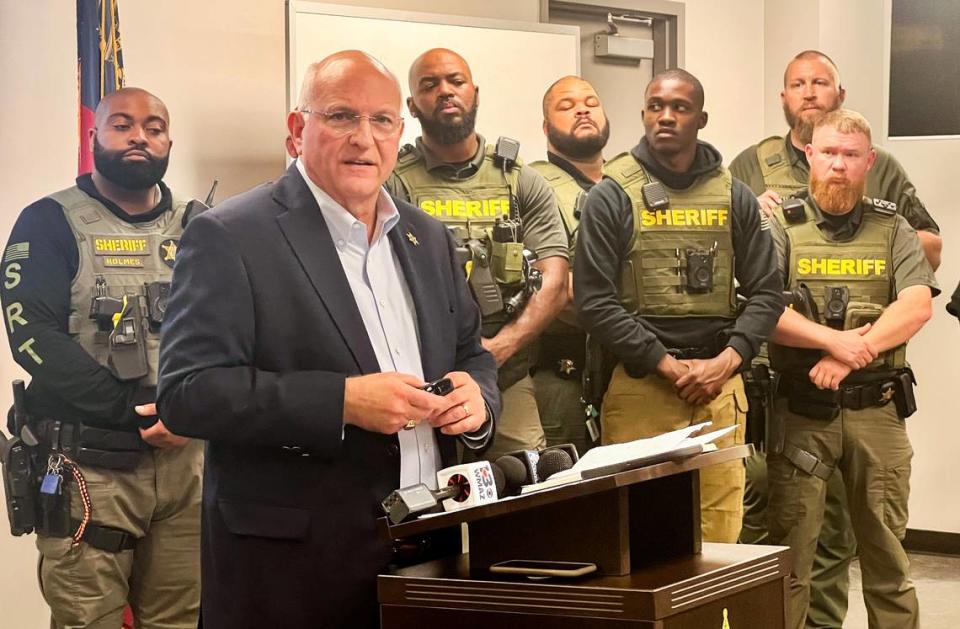 Bibb County Sheriff David Davis, surrounded by investigators, talks to the media Monday afternoon about the capture of four escaped Macon jail inmates.