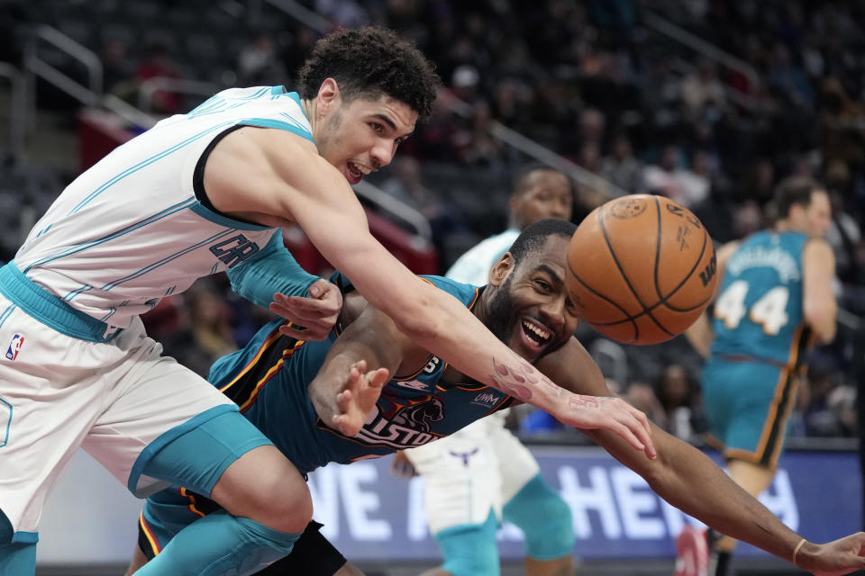 Charlotte Hornets guard LaMelo Ball (1) an dDetroit Pistons guard Alec Burks (5) chase the loose ball during the second half of an NBA basketball game, Friday, Feb. 3, 2023, in Detroit. (AP Photo/Carlos Osorio)