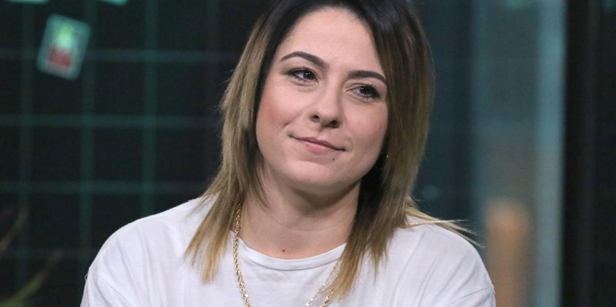 singersongwriter lucy spraggan during an interview where she is wearing a white t shirt with a green logo