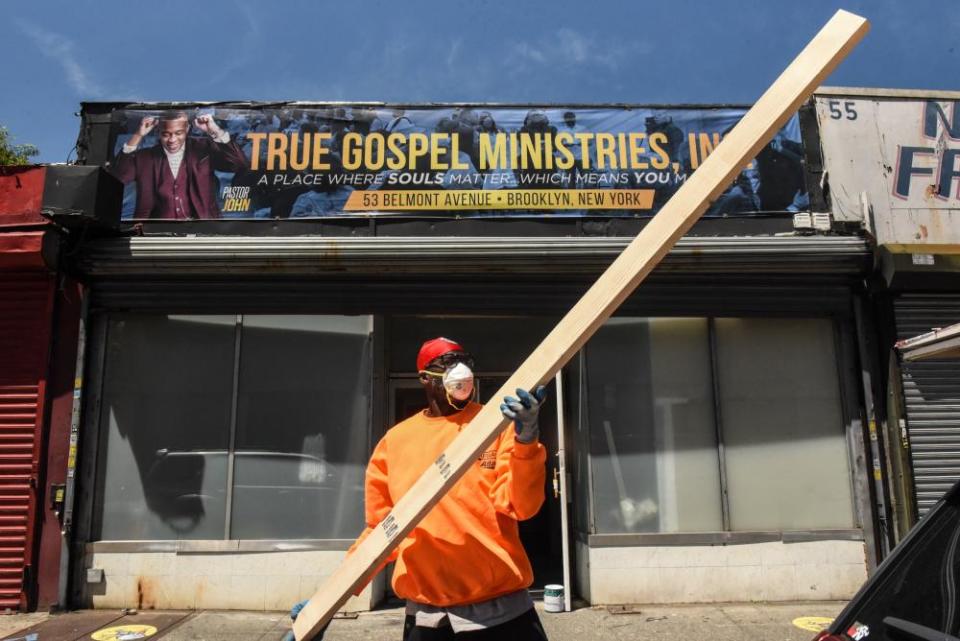 A worker grasps a piece of wood for a project in a church in Brownsville.