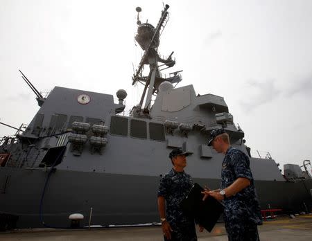 U.S. Navy's Pacific Fleet Commander Admiral Harry Harris (L) speaks to an officer outside USS Spruance, an Arleigh Burke-class guided missile destroyer, moored in Singapore January 22, 2014. REUTERS/Edgar Su/File Photo