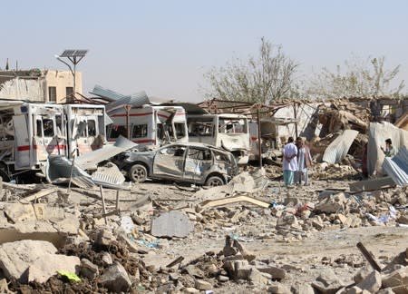 Damaged vehicles are seen at the site of a car bomb attack in Qalat, capital of Zabul province