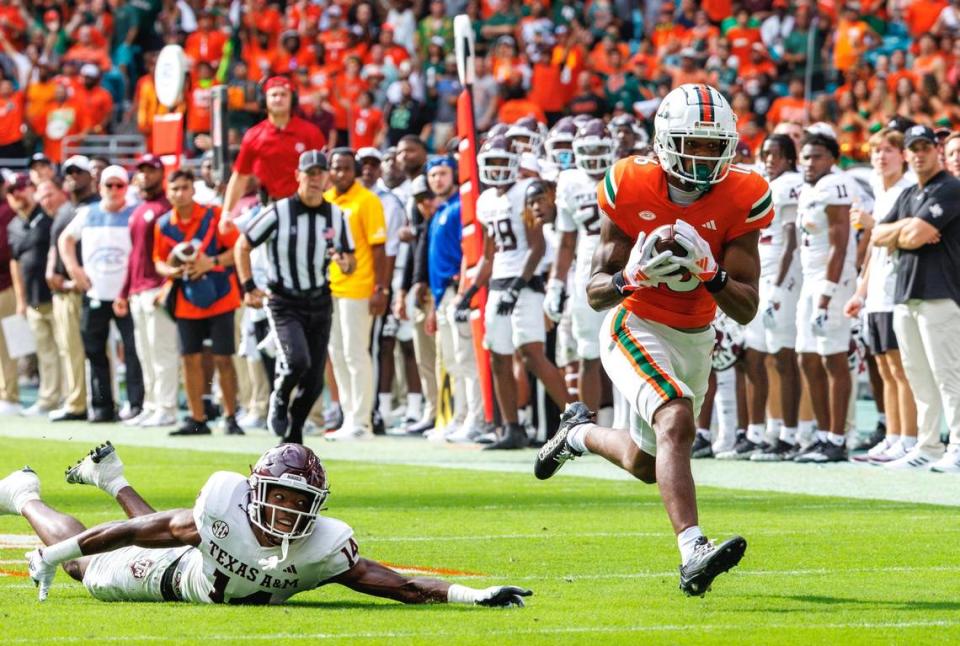 Miami Hurricanes wide receiver Isaiah Horton (16) runs after catching a pass as Texas A&M Aggies defensive back Jayvon Thomas (14) defends during the second quarter of an NCAA non conference game at Hard Rock Stadium on Saturday, Sept. 9, 2023 in Miami Gardens, Florida.