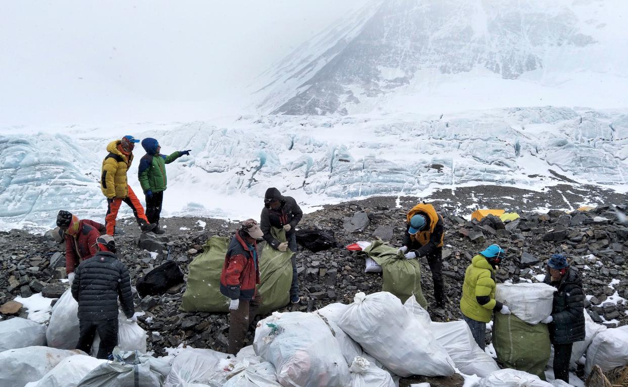 In this May 8, 2017, file photo released by Xinhua News Agency, people collect garbage at the north slope of Mount Everest in southwest China's Tibet Autonomous Region. (Photo: ASSOCIATED PRESS)