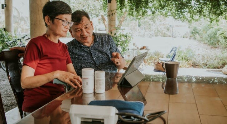 Asian couple studies their purchase contract