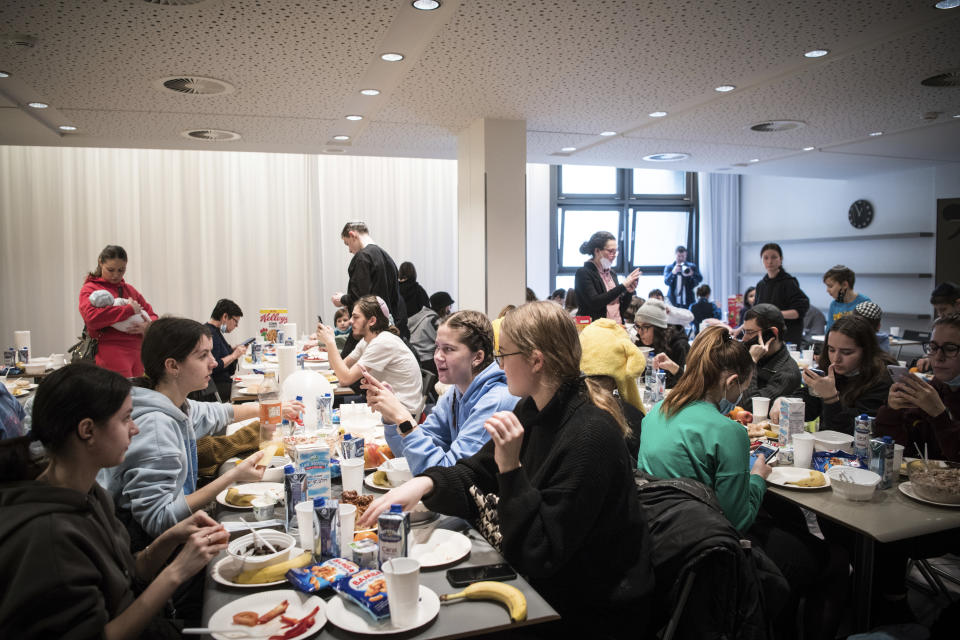 Children from an orphanage in Odesa, Ukraine, eat after their arrival at a hotel in Berlin, Friday, March 4, 2022. More than 100 Jewish refugee children who were evacuated from a foster care home in war-torn Ukraine and made their way across Europe by bus have arrived in Berlin. (AP Photo/Steffi Loos)