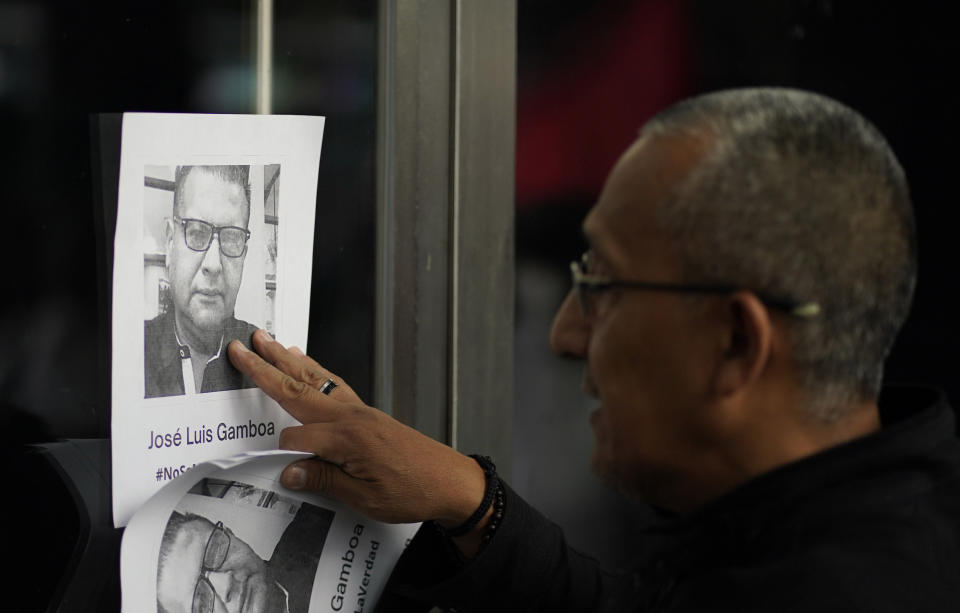 FILE - A man places photos of slain journalists after the murder of journalist Fredid Roman during a vigil to protest the crime, outside Mexico's Attorney General's office in Mexico City, Wednesday, Aug. 24, 2022. According to a report released Tuesday, Jan. 24, 2023, by the New York-based Committee to Protect Journalists, killings of journalists around the world jumped by 50% in 2022 compared to the previous year, driven largely by murders of reporters in the three deadliest countries: Ukraine, Mexico and Haiti. (AP Photo/Eduardo Verdugo, File)