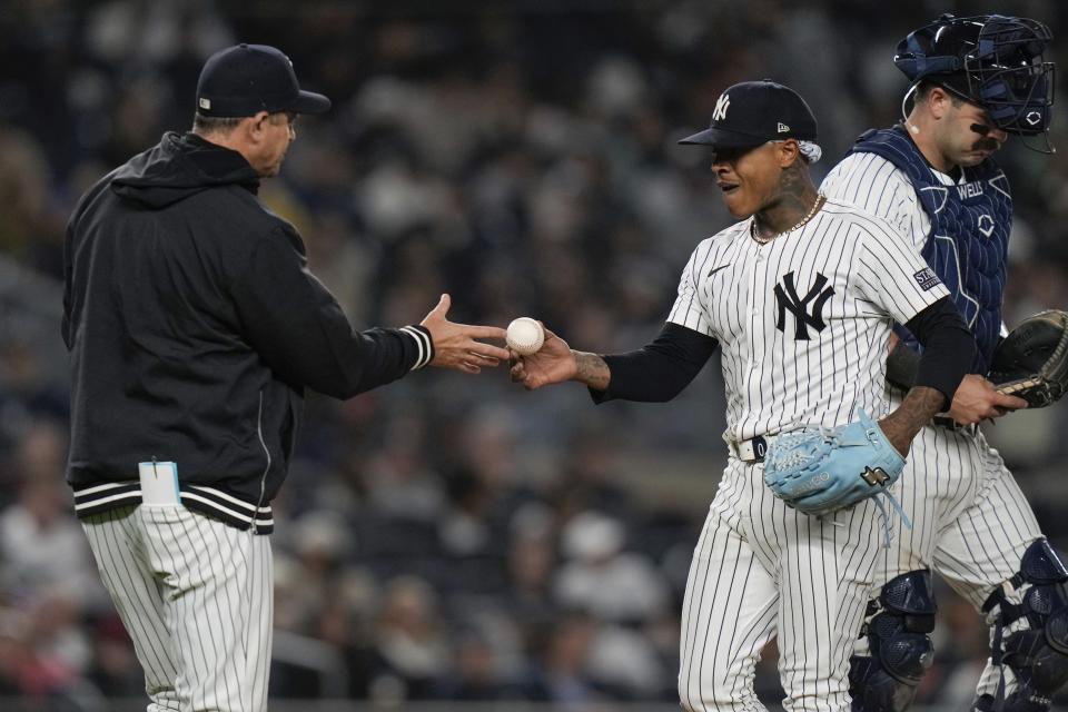 New York Yankees pitcher Marcus Stroman hands the ball to manager Aaron Boone as he leaves during the sixth inning of a baseball game against the Detroit Tigers, Friday, May 3, 2024, in New York. (AP Photo/Frank Franklin II)