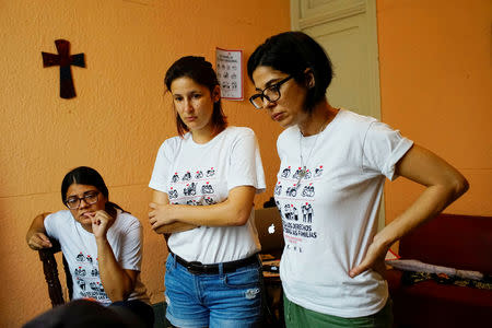 Elaine Saralegui (R), Susana Hernandez (C) and Angela Laksmi, activists supporting the lesbian, gay, bisexual and transgender community (LGBT), talk to designers (not pictured) as they work in Havana, Cuba, October 9, 2018. REUTERS/Alexandre Meneghini