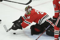 Chicago Blackhawks goalie Petr Mrazek (34) makes a save during the third period of an NHL hockey game against the Carolina Hurricanes Sunday, April 14, 2024, in Chicago. (AP Photo/Paul Beaty)