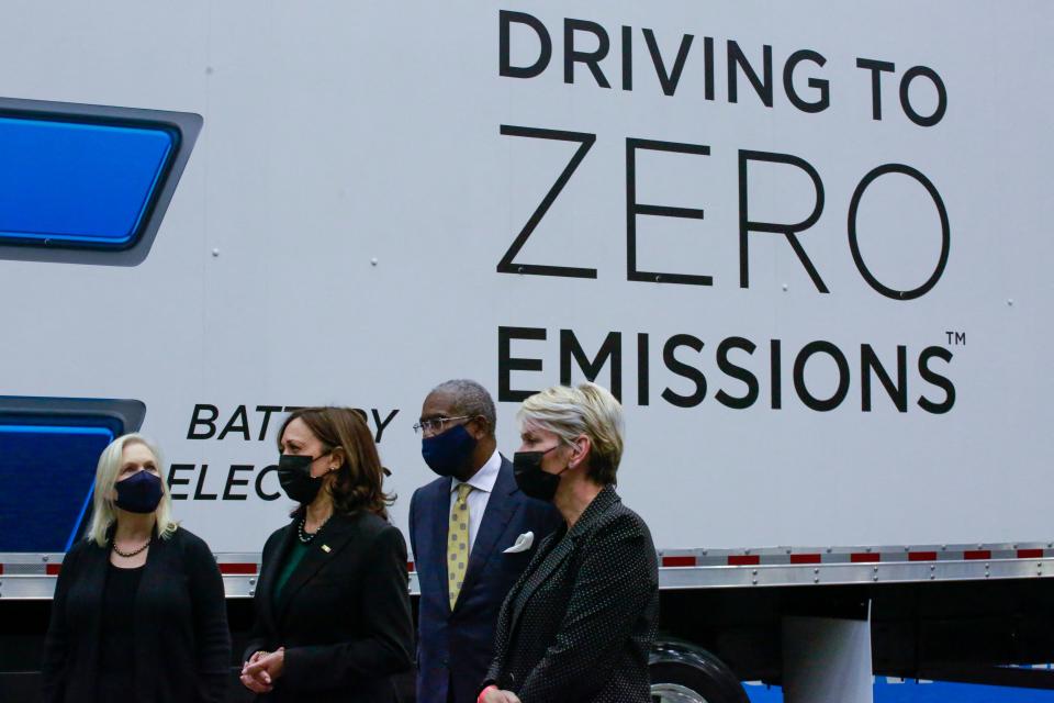 Sen. Gillibrand, VP Harris, Rep. Gregory Meeks, and Sec. Granholm stand next to a heavy-duty electric truck as they visit a hangar at JFK Airport in New York on November 1, 2021. (Photo by KENA BETANCUR / AFP)