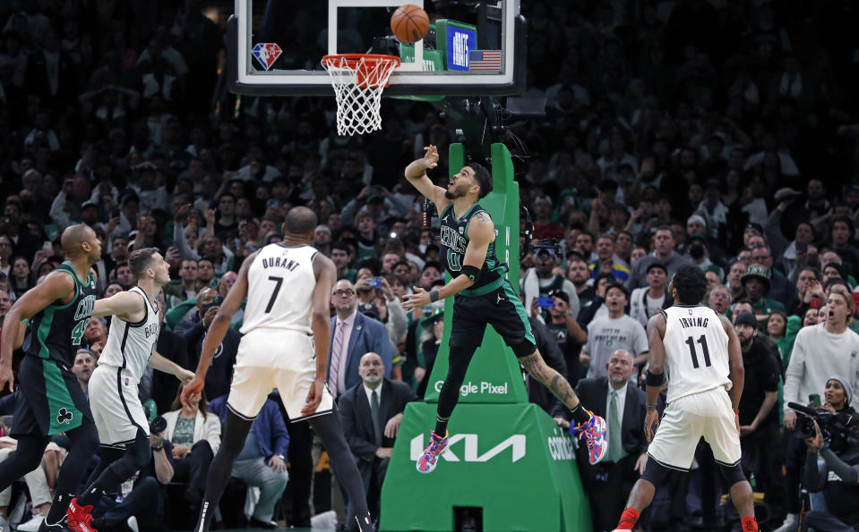 Boston - April 17: The Celtics Jayson Tatum (0) watches his shot go in at the buzzer to give Boston a 115-114 victory. The Nets Kyrie Irving (11, right) and Kevin Durant (7, left) look on.  The Boston Celtics hosted the Brooklyn Nets in Game One of the NBA first round playoff series at the TD Garden in Boston on April 17, 2022. (Photo by Jim Davis/The Boston Globe via Getty Images)