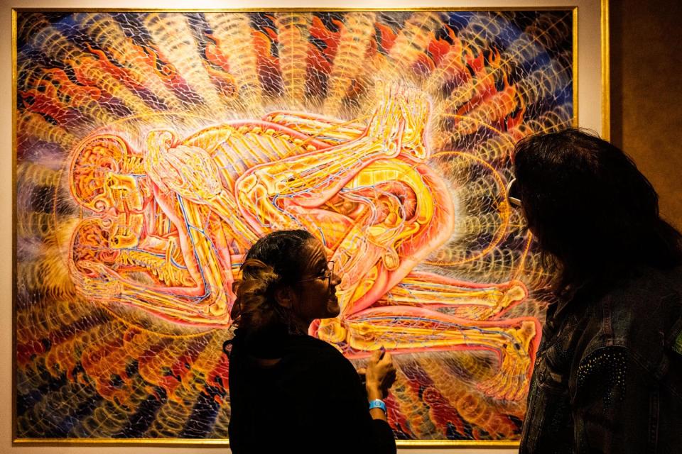 Entheon visitors inside the Progress of the Soul Gallery, taking in ‘Copulating’ by Alex Grey.