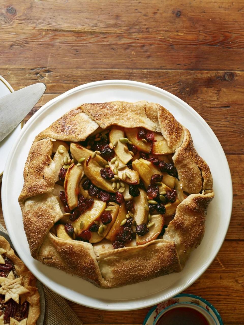 apple crostata with dried cranberries and cherries and pumpkin seeds