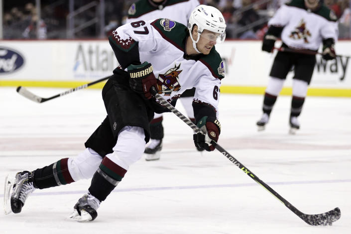 Arizona Coyotes left wing Lawson Crouse skates with the puck during the second period of an NHL hockey game against the New Jersey Devils Wednesday, Jan. 19, 2022, in Newark, N.J. (AP Photo/Adam Hunger)