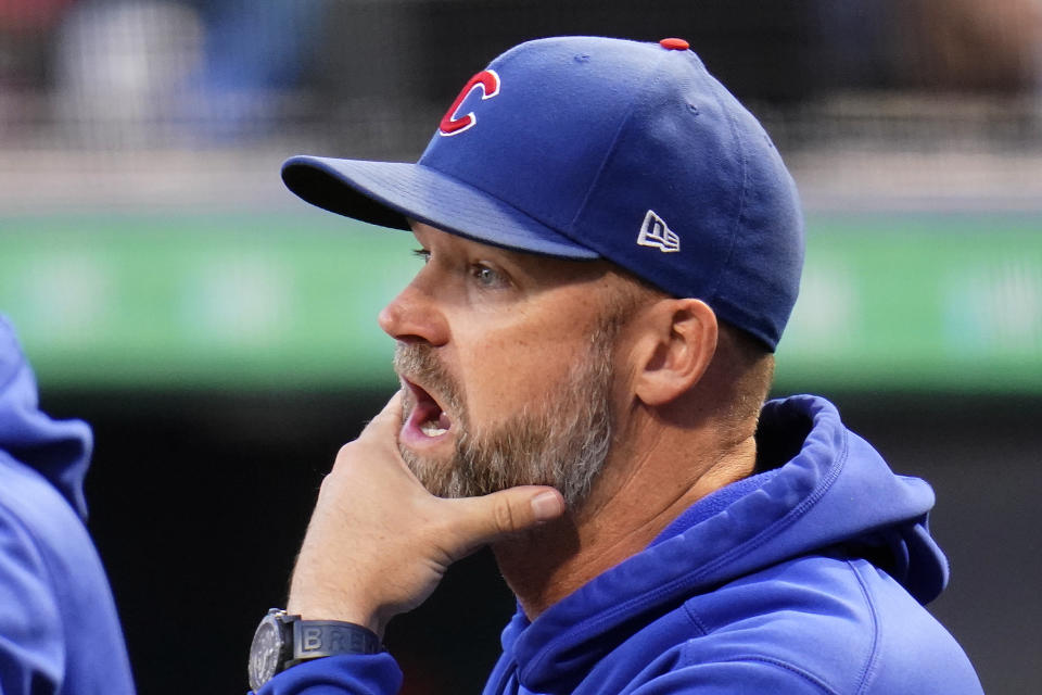 Chicago Cubs manager David Ross stands in the dugout during the first inning of a baseball game against the Pittsburgh Pirates in Pittsburgh, Tuesday, Sept. 28, 2021. (AP Photo/Gene J. Puskar)