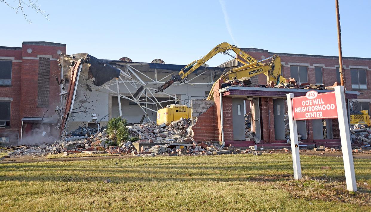 The walls of the Ocie Hill Neighborhood Center fall during demolition Wednesday morning.