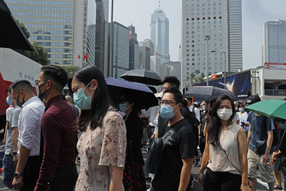 Protesters march with face mask during a flash mob protest in Hong Kong, on Friday, Oct. 11, 2019. Hundreds of masked protesters gathered at Chater Garden in central Hong Kong on Friday to rally against police brutality and show their support for students who have been arrested during the ongoing anti-government demonstrations. (AP Photo/Kin Cheung)