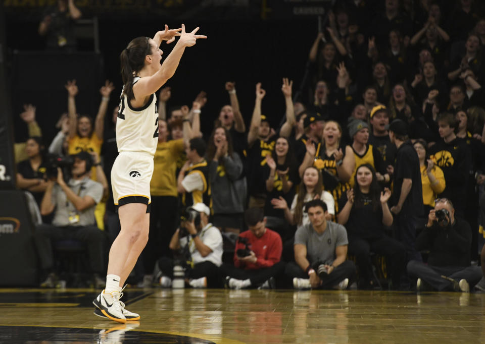 Iowa guard Caitlin Clark (22) celebrates after a 3-point basket against Ohio State during the second half of an NCAA college basketball game, Sunday, March 3, 2024, in Iowa City, Iowa. (AP Photo/Cliff Jette)