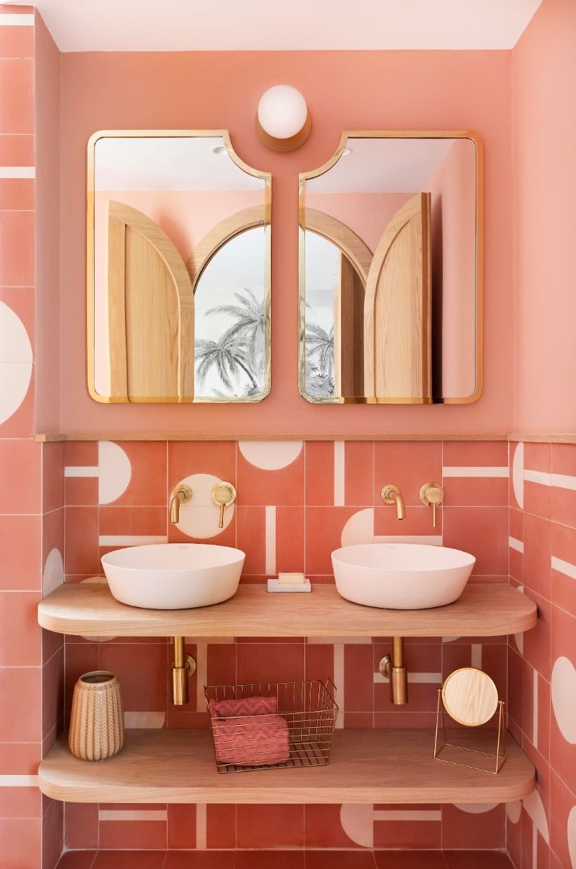 In the pink bathroom, the lighting is by Nuura, the sinks are by Bathco, the tiles are bespoke, and the mirrors were designed by Noé Prades Studio.