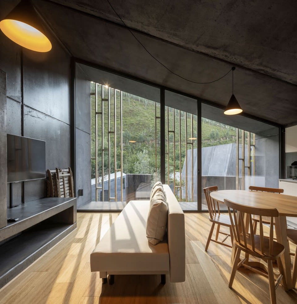 Natural light-filled living area inside a Paradinha Village Resort modular cabin.