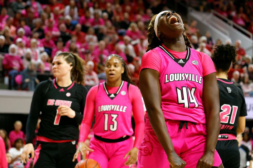 Louisville's Olivia Cochran (44) celebrates a foul on N.C. State's River Baldwin (1) as teammate Merissah Russell looks on Monday night in Raleigh, North Carolina.