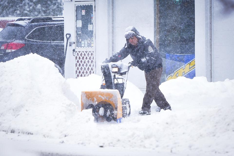 A man clears the sidewalk with a snowblower during heavy snowfall in Herkimer on Tuesday, Feb. 2, 2021.