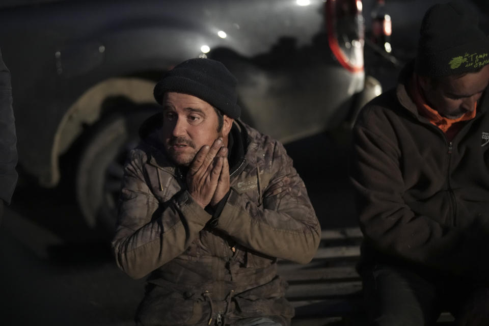 Farmers spend the night at a highway barricade in Aix-en-Provence, southern France, Tuesday, Jan. 30, 2024. France's protesting farmers encircled Paris with traffic-snarling barricades Monday, using hundreds of lumbering tractors and mounds of hay bales to block highways leading to France's capital to pressure the government over the future of their industry. (AP Photo/Daniel Cole)