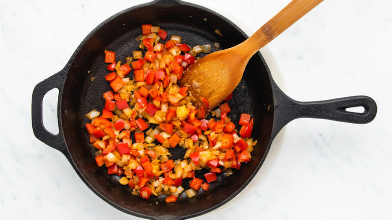 Onion, garlic, and red pepper frying in skillet