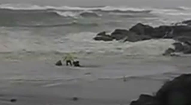 Mr Lou finally reached the couple and tries to pull them back, but seconds later all three are swept up by another wave. Photo: Youtube/ Olivier Lou