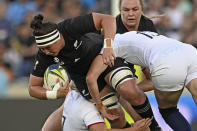 New Zealand's Charmaine McMenamin is tackled by England defenders during the final of the women's rugby World Cup at Eden Park in Auckland, New Zealand, Saturday, Nov.12, 2022. (Andrew Cornaga/Photosport via AP)