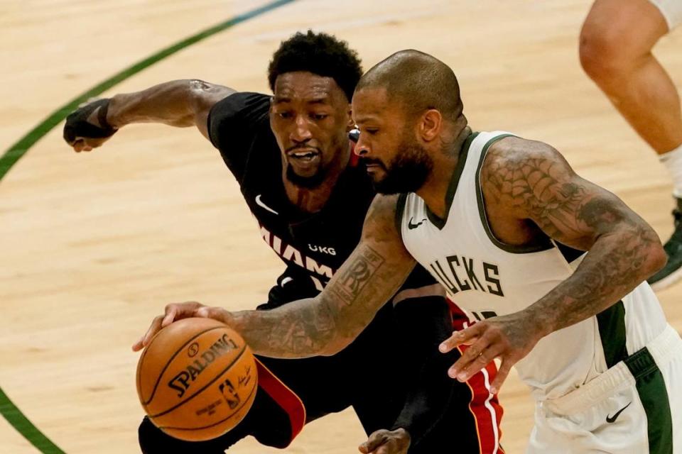 Milwaukee Bucks’ P.J. Tucker drives past Miami Heat’s Bam Adebayo during the second half of an NBA basketball game Saturday, May 15, 2021, in Milwaukee.