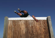 <p>A U.S. Border Patrol trainee climbs over an obstacle course wall at the U.S. Border Patrol Academy on August 3, 2017 in Artesia, N.M. (Photo: John Moore/Getty Images) </p>