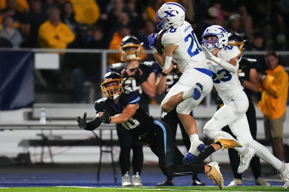 St. Xavier Bombers defensive back Andrew Weber (20) intercepts a pass in the first half of a high school football game between the St. Xavier Bombers and the Moeller Crusaders, Friday, Sept. 15, 2023, at Welcome Stadium in Dayton, Ohio.