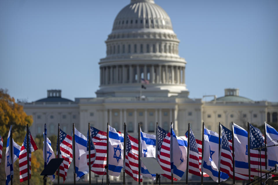 U.S. and Israeli flags fly on the stage in front of the Capitol at the 