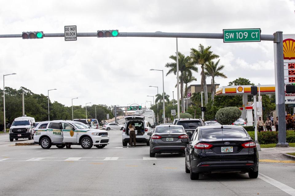 Police block an intersection near the Miami-Dade Kendall Campus in Miami, Fla., on Sunday, June 6, 2021. Three people are dead and at least six others injured following a shooting at a Florida graduation party, the latest in a string of such violence in the Miami area, police said Sunday. One of those killed was a state corrections officer, Miami-Dade police Director Freddie Ramirez told news outlets. (Daniel A Varela/Miami Herald via AP)